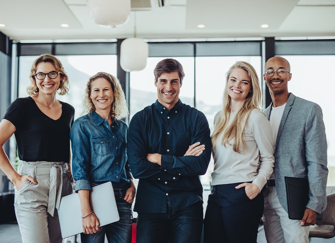 Employee Benefits - Portrait of Smiling Business Team Standing in a Modern Office
